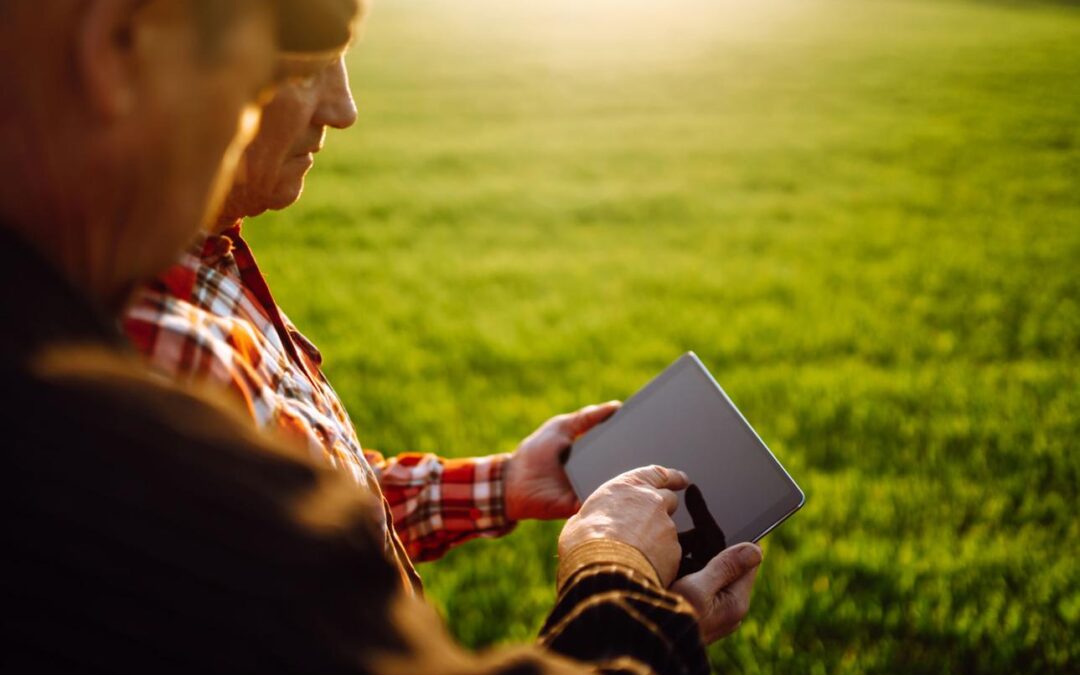 Growers reviewing field conditions and agricultural data while making farm management decisions